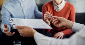 Close Up Of Unrecognizable Couple Signing A Contract With Financ